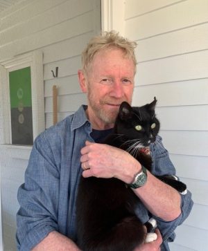 Illustrator Marc Rosenthal with his cat, Pete