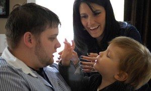 botmultichillt_adams_holds_his_three-year-old_son_while_bcba_therapist_assists-wikimedia-commons-8229955-2